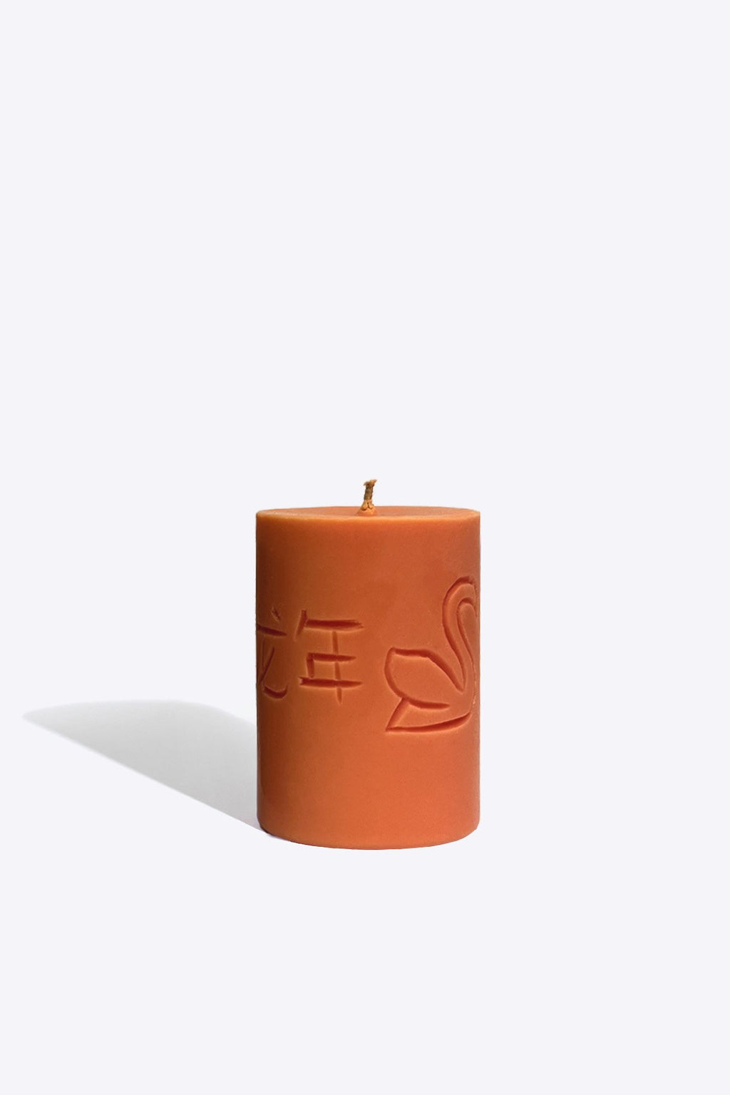 3. Smells Like Spells Candle of the Year 2024 with engraved symbols, shown in studio setting