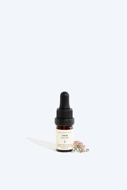 1. Smells Like Spells Essential Oil Blend THOR in 5 ml glass bottle with pipette, shown with floral accent