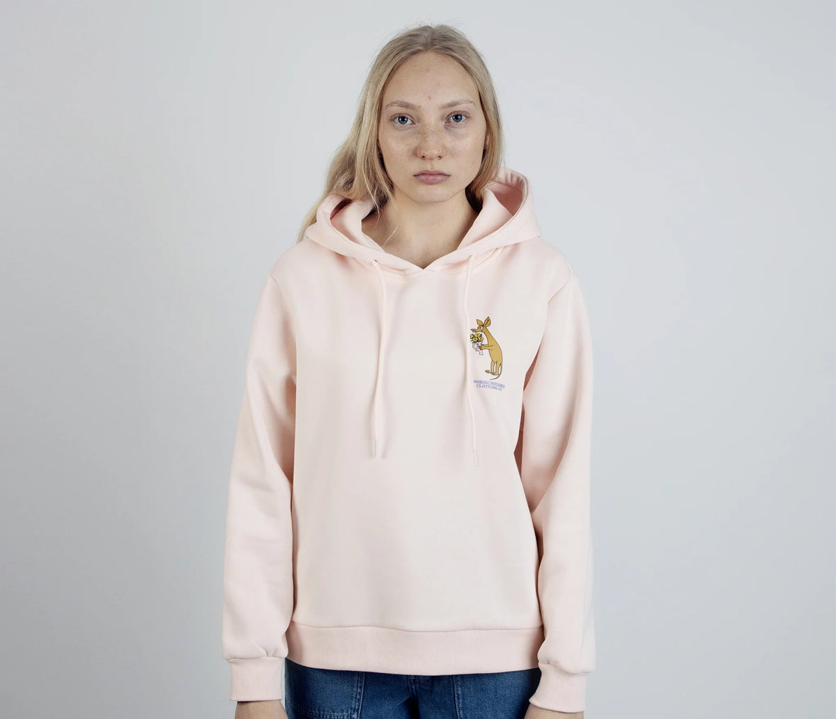 1. Women's light pink Sniff Flower Bouquet Hoodie by Moomin, worn by model in studio setting