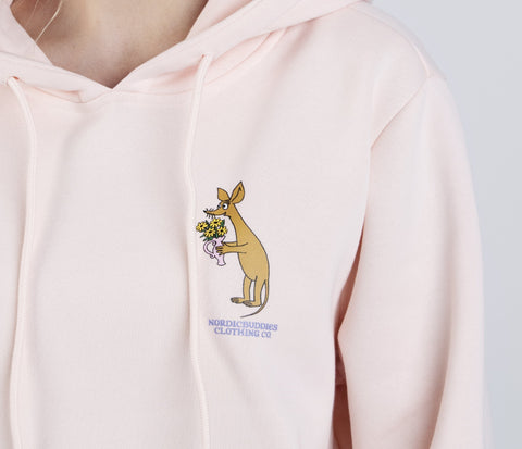 3. Close-up of Sniff character holding flowers on light pink Moomin hoodie