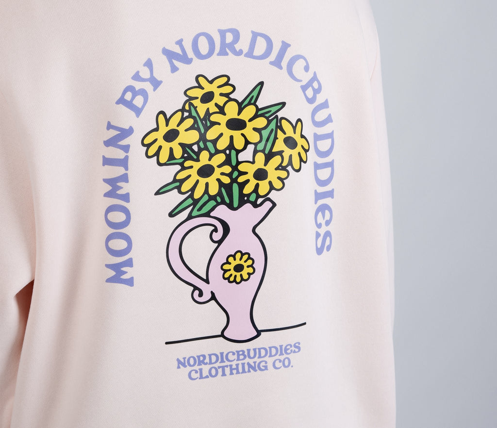 4. Close-up of flower bouquet graphic on back of light pink Moomin hoodie