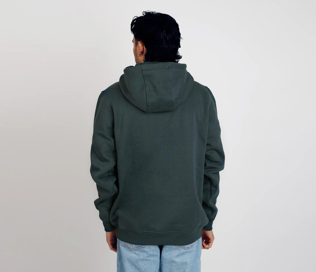 2. Back view of men's dark green Snufkin Fishing Hoodie by Moomin, styled with light denim in studio
