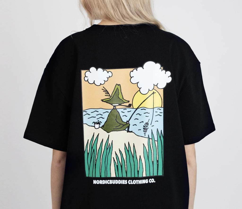 1. Women's Snufkin Fishing T-Shirt by Moomin, shown from the back with colorful graphic, studio setting