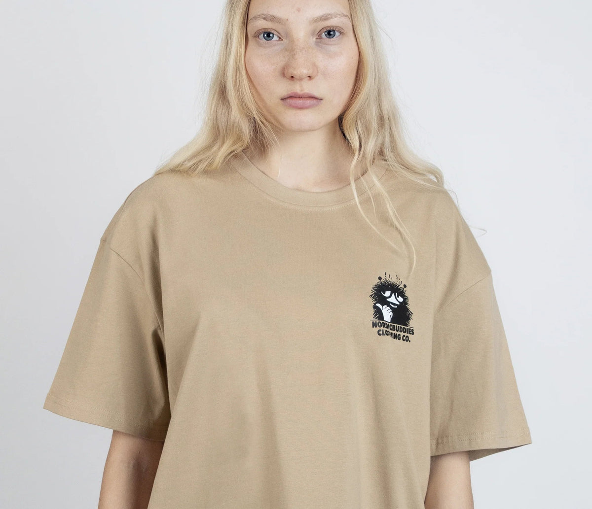 6. Women's unisex Stinky Plotting T-Shirt by Moomin, front view with small logo in studio