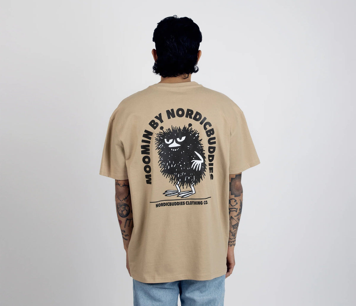 3. Men's unisex Stinky Plotting T-Shirt by Moomin, back view with NordicBuddies logo in studio