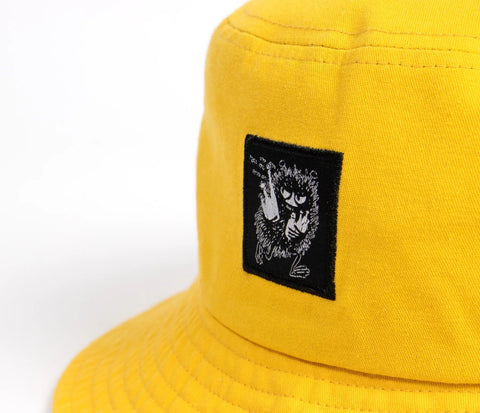 5. Flat lay of yellow Stinky Bucket Hat by Moomin, highlighting design and patch