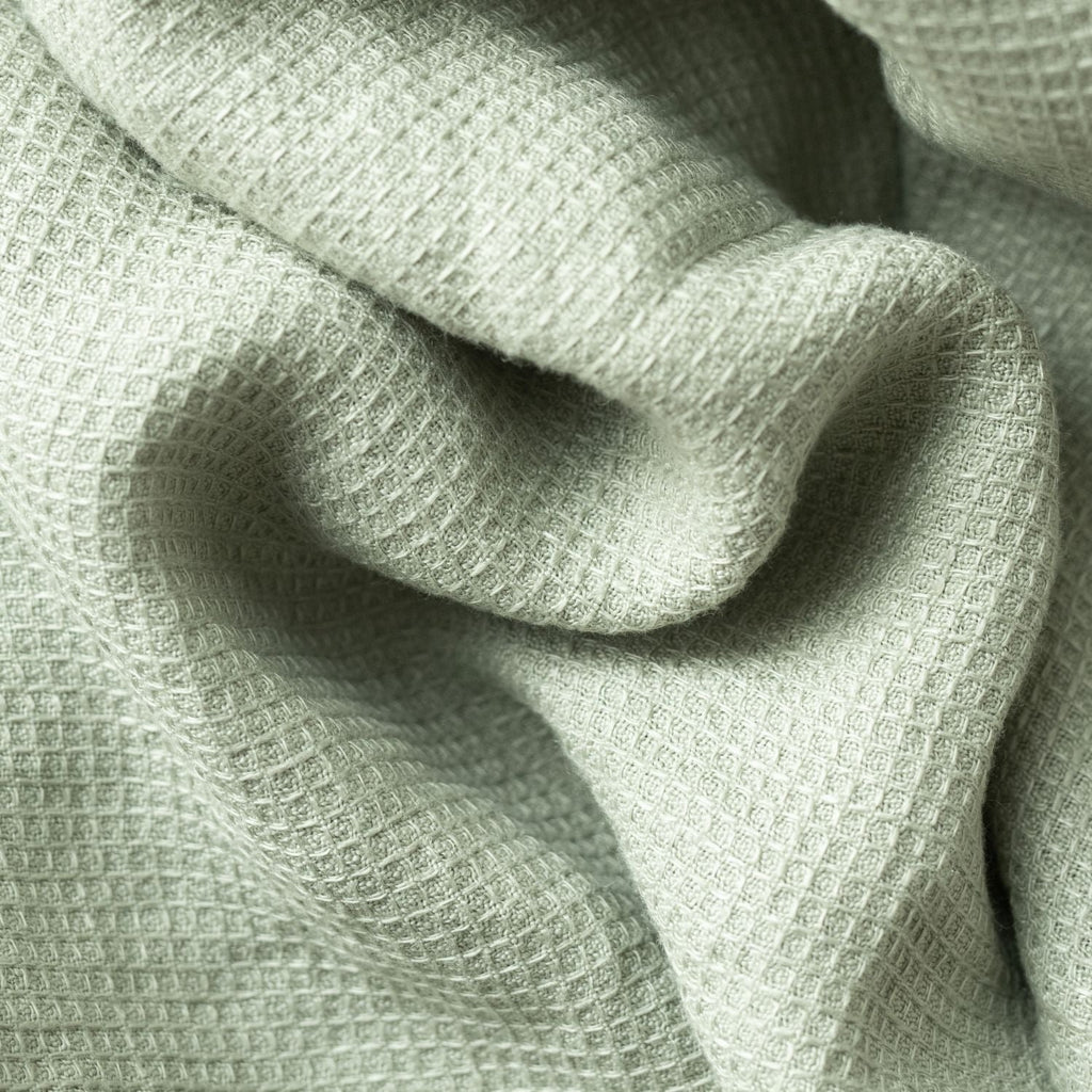 4. Detailed view of sage green waffle linen fabric highlighting texture and weave