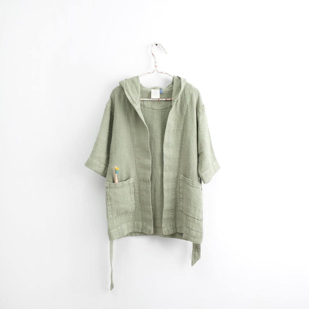 2. Kids sage green linen bathrobe with hood and pockets hanging on white background