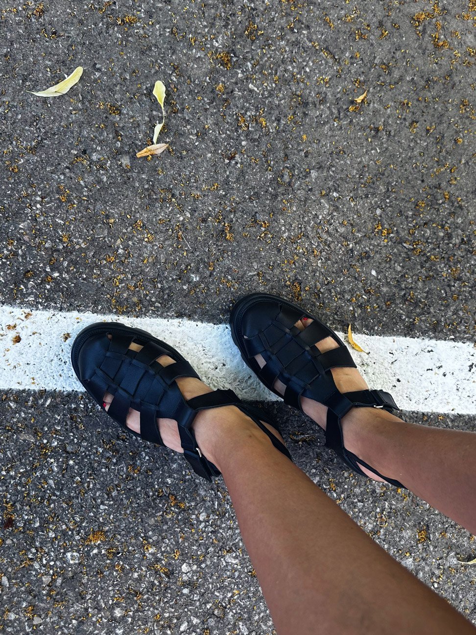 1. Women's black woven leather sandals by Samelin worn outdoors on pavement