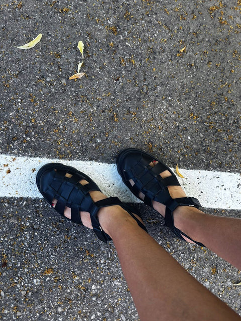 1. Women's black woven leather sandals by Samelin worn outdoors on pavement