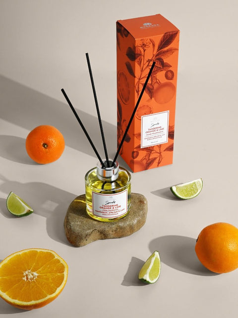 1. Magrada Organic Cosmetics 'Spunky' home fragrance with tangerine, orange, and lime, 100 ml, displayed with natural reed sticks and citrus fruits, eco-friendly and handmade in Estonia
