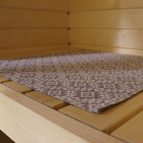 1. Sauna bench with a single LOKO seating pad featuring Harju County mitten pattern in linen and cotton blend
