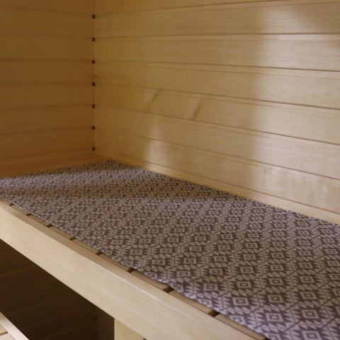 1. Sauna bench with LOKO seating pad featuring Harju County mitten pattern in linen-cotton blend