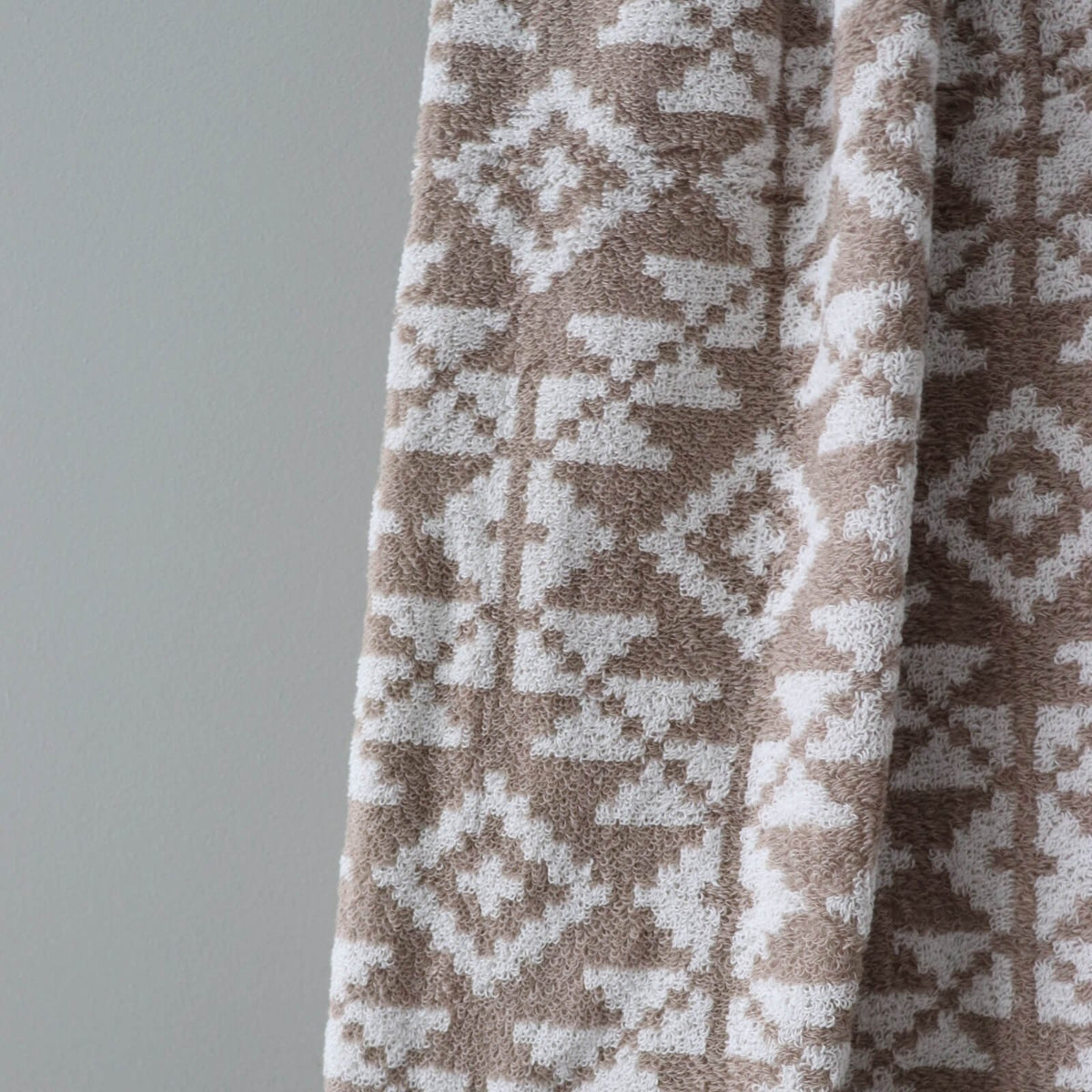 3. Close-up of beige and white Harju County mitten pattern on soft terry sauna towel