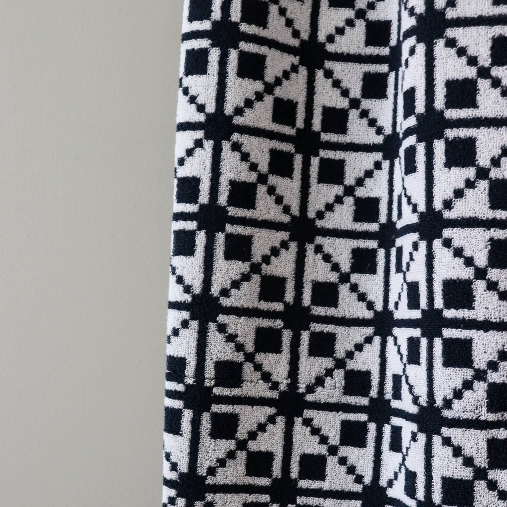 3. Close-up of black and white Virumaa mitten pattern on soft terry cotton sauna towel