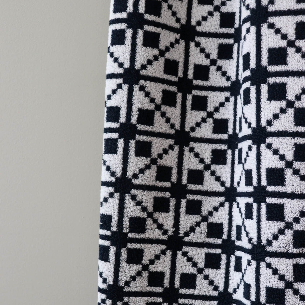 3. Close-up of black and white Virumaa mitten pattern on soft terry cotton sauna towel