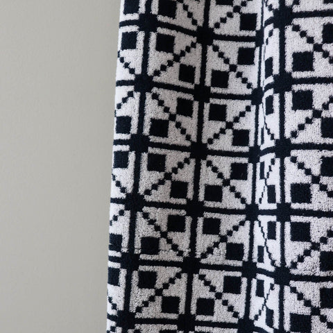 3. Close-up of black and white Virumaa mitten pattern on soft terry cotton sauna towel