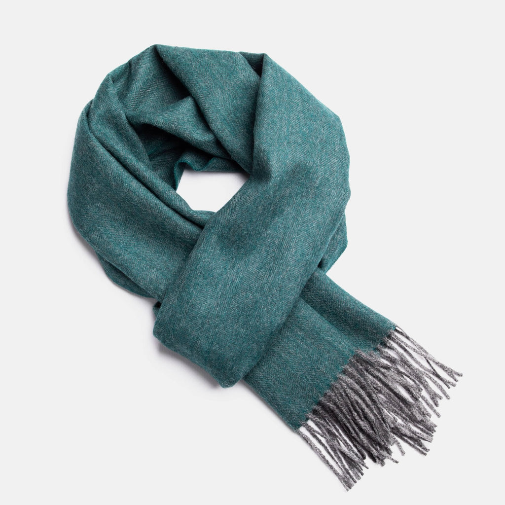 2. Studio image of Alpaka natural baby alpaca wool scarf in teal with fringe detail
