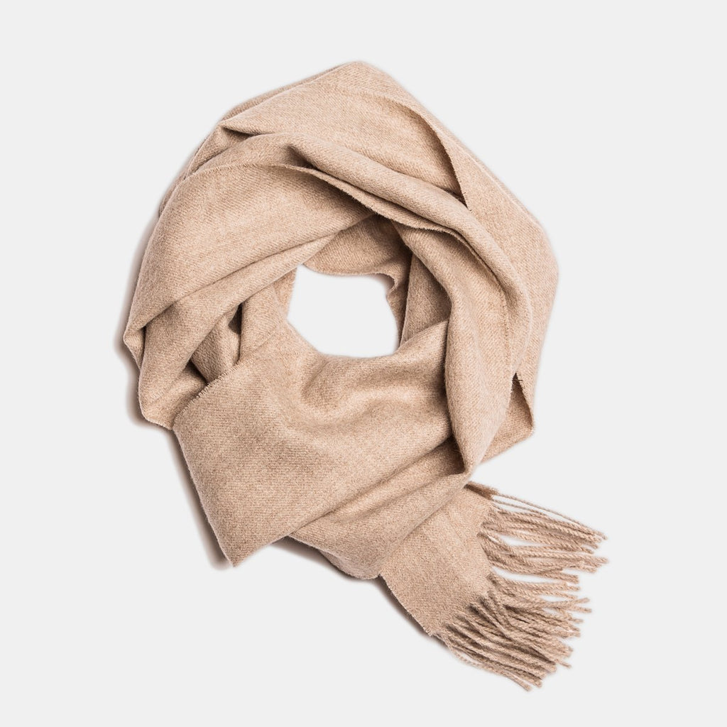 8. Wheat Alpaka baby alpaca wool scarf with fringe detail in flat lay