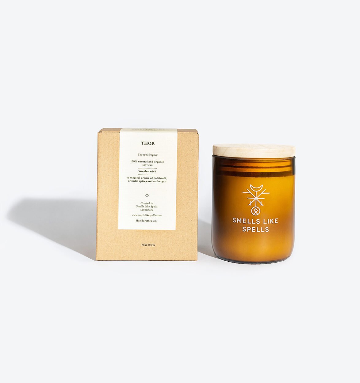 3. Smells Like Spells Scented Candle THOR with packaging, amber glass jar and wooden lid, studio setting