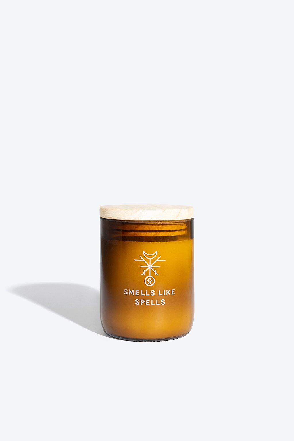 3. Smells Like Spells MIMIR scented candle in amber glass jar with wooden lid, studio shot