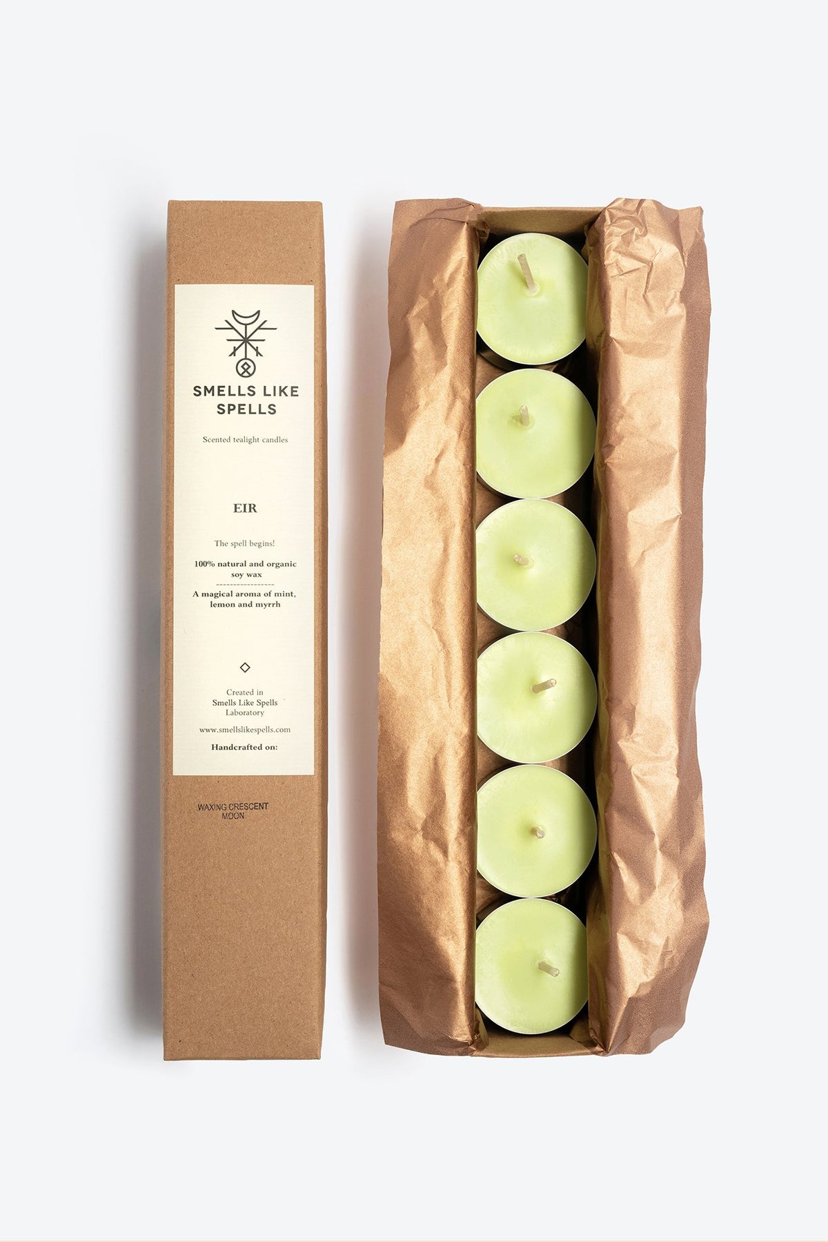 2. Open box of Smells Like Spells Scented Tealight Candles EIR, featuring six green soy wax candles