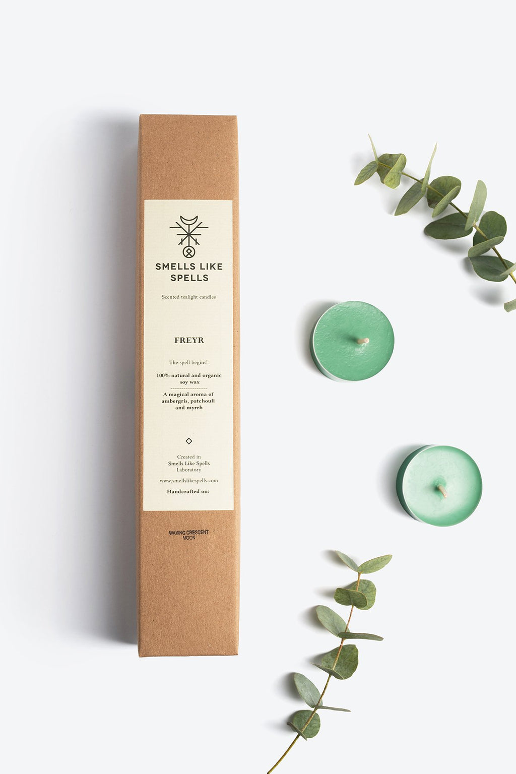 3. Smells Like Spells Scented Tealight Candles FREYR with green candles and eucalyptus, emphasizing eco-friendly packaging