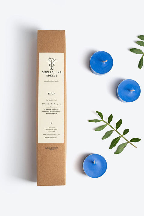 1. Smells Like Spells Scented Tealight Candles THOR with blue soy wax, shown with packaging and green leaves