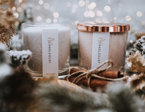 4. Candledust Midnight and Rhubarb Sparkle powdered candles in glass, with rose gold lid, surrounded by holiday decor