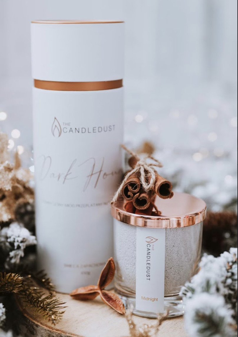 6. Candledust Midnight powdered candle with rose gold lid and packaging, styled with cinnamon and festive elements