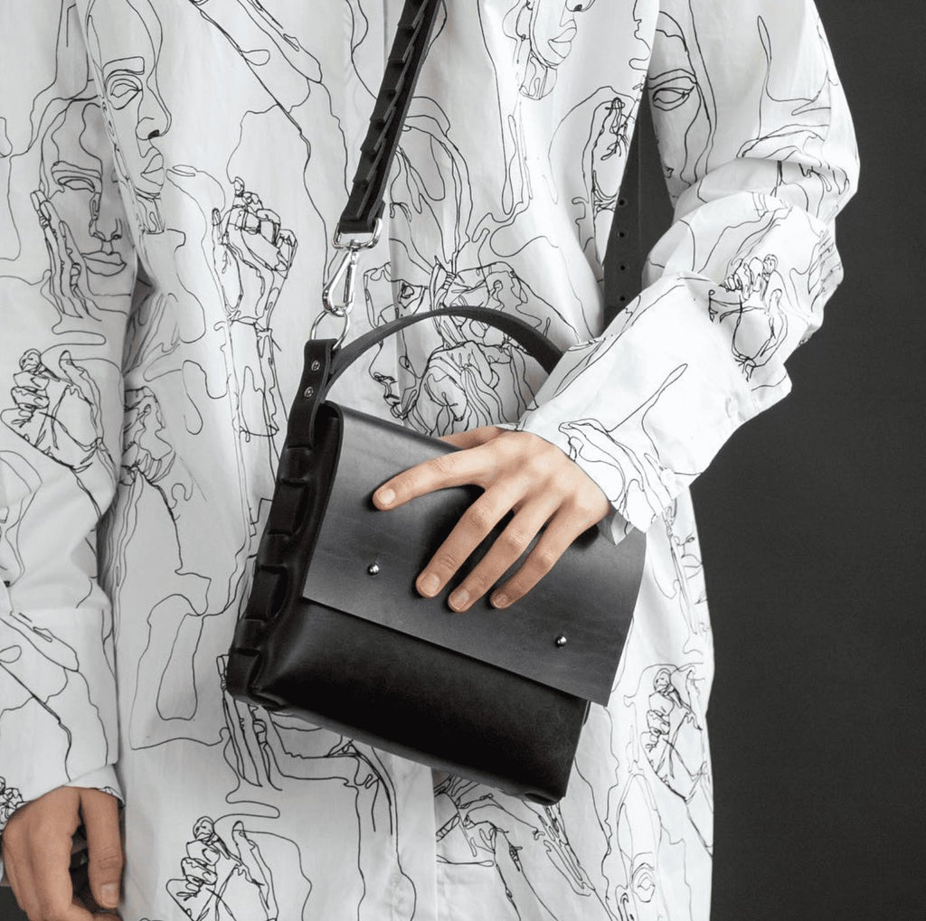 1. Women's Agatha no.2 handbag by PYKOK in black leather, worn crossbody with adjustable strap, styled with a patterned shirt