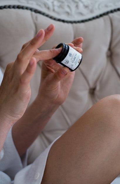 2. Woman applying MaiWistik CURETIK Deep Moisturizing Ointment 30ml, highlighting product use and texture