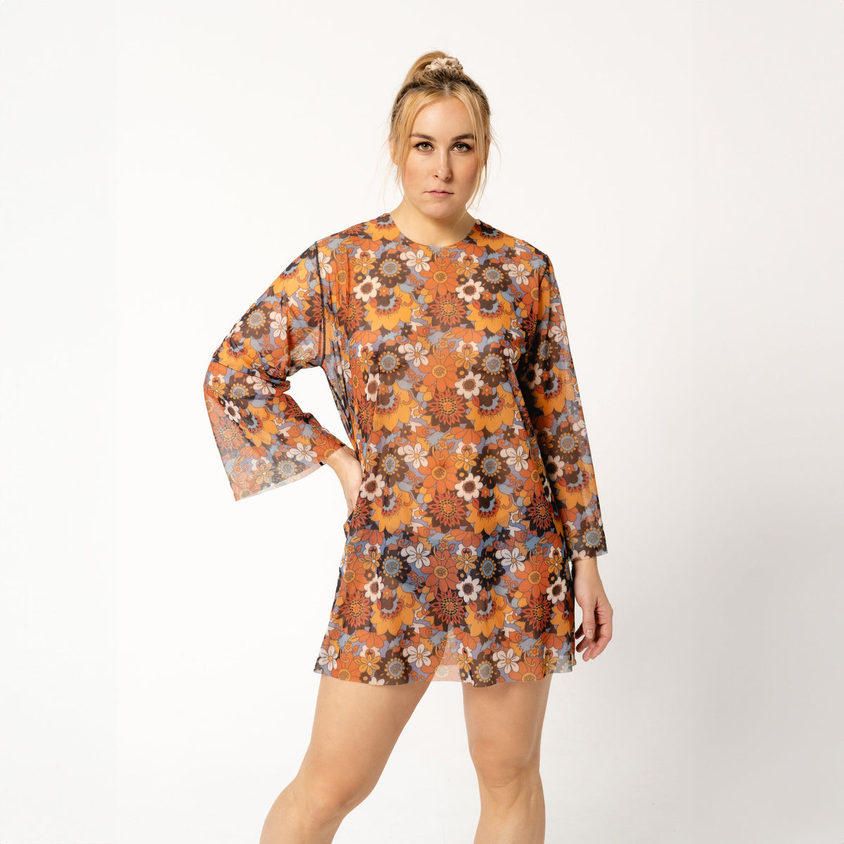 1. Women's tan-through tunic Kristel by Smarttan in floral pattern, worn by model in studio setting