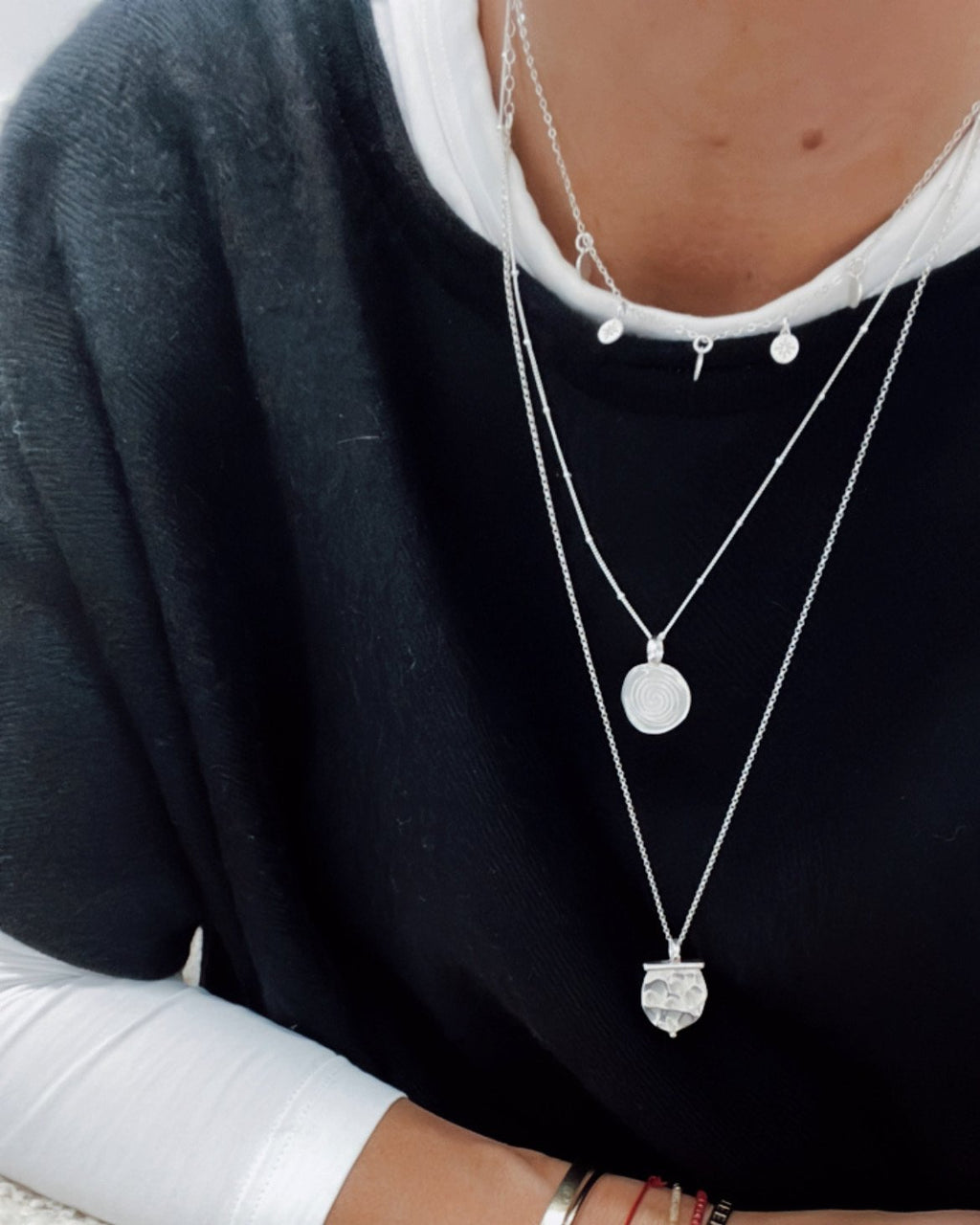 3. Women's silver Stargazer Choker by New Vintage by Kriss layered with other necklaces, styled with a black top