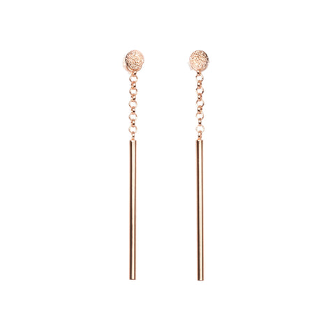 2. Studio image of MyaMoon Stardust Falling Earrings in rose gold with long drop and chain pendant