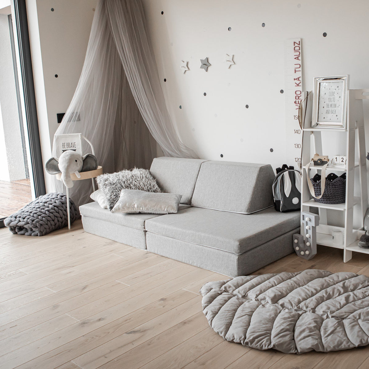 13. Beige Monboxy play mattress set used as a sofa in a cozy, decorated room
