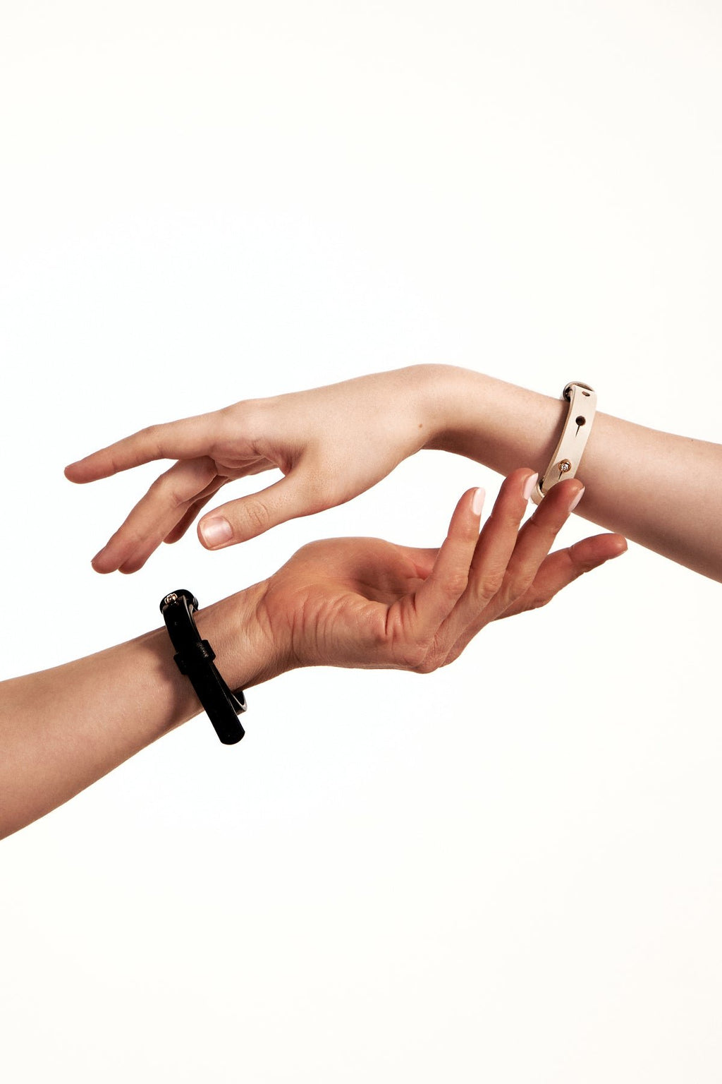 1. Women's ivory leather bracelet with brass fastener by Tairi Roosve, shown on wrist in lifestyle setting
