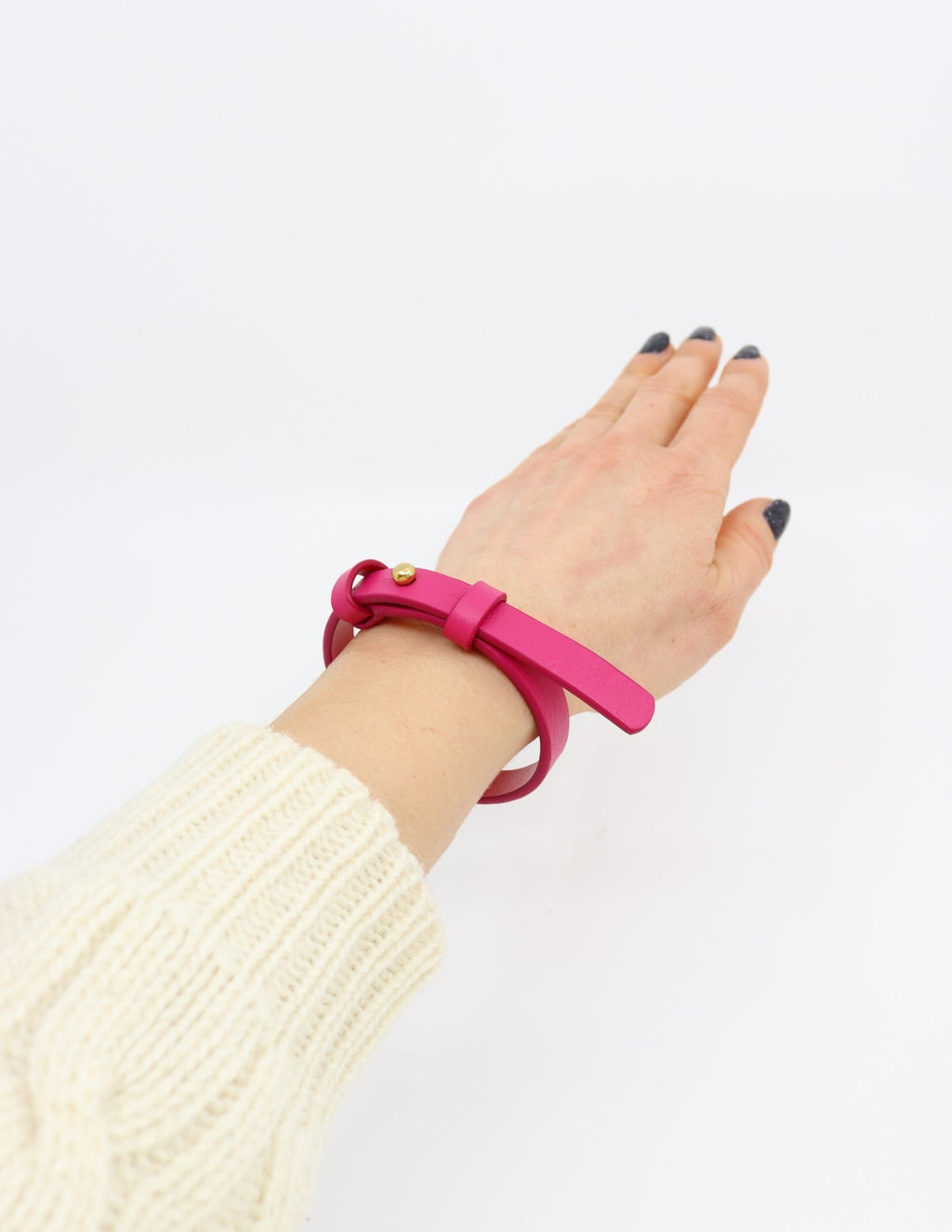 1. Women's fuchsia leather bracelet with brass fastener by Tairi Roosve, worn on wrist