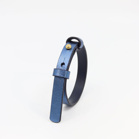 1. Tairi Roosve metallic blue leather bracelet with brass fastener, shown in studio setting