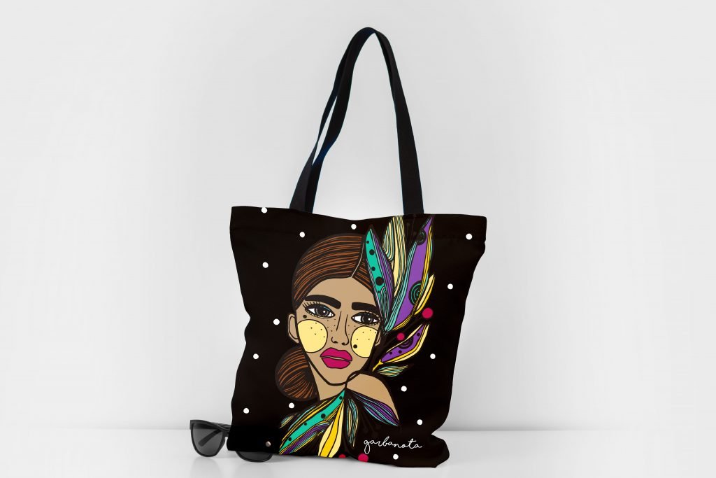 5. Garbanota HANDBAG LILY - COLORED with colorful graphic design, shown with sunglasses in studio