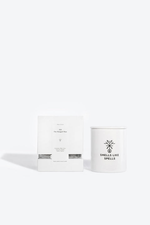 2. Smells Like Spells scented candle and packaging, featuring The Hanged Man design, in studio setting