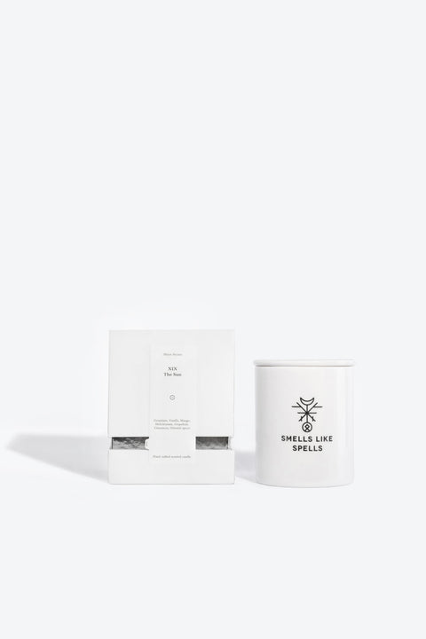 4. Smells Like Spells Scented Candle THE SUN with packaging, white porcelain container, studio setting