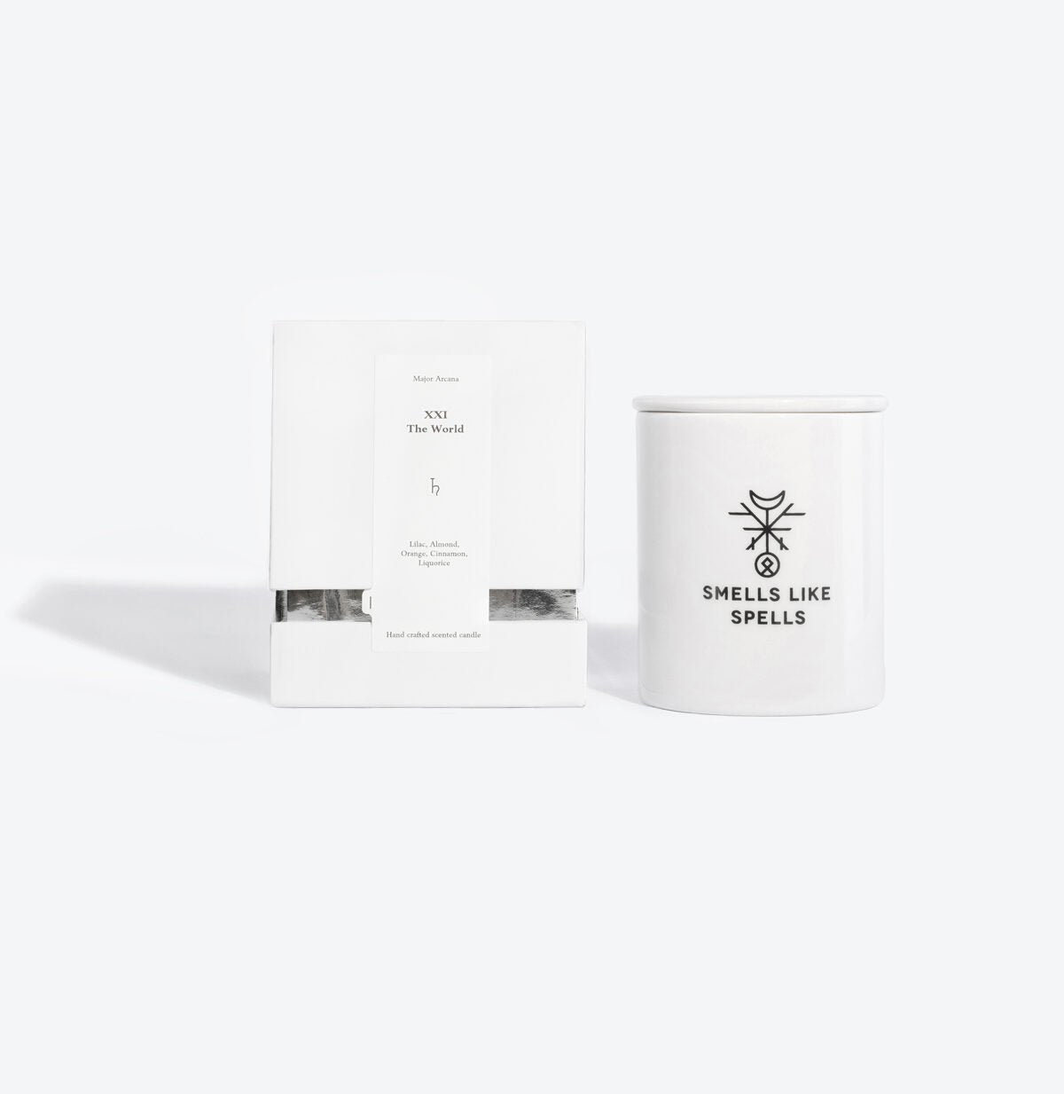 3. Smells Like Spells scented candle with packaging, featuring The World Tarot card, studio setting