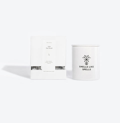 3. Smells Like Spells scented candle with packaging, featuring The World Tarot card, studio setting