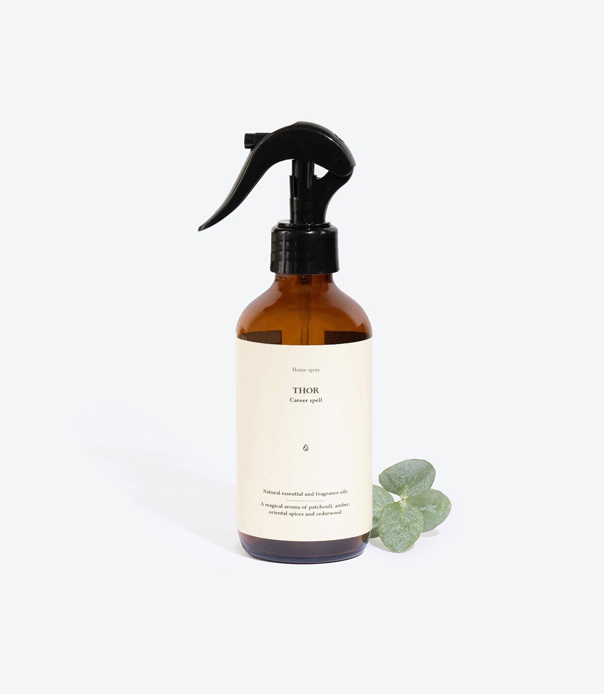 1. Smells Like Spells Perfumed Home Spray THOR in amber bottle with eucalyptus, studio setting