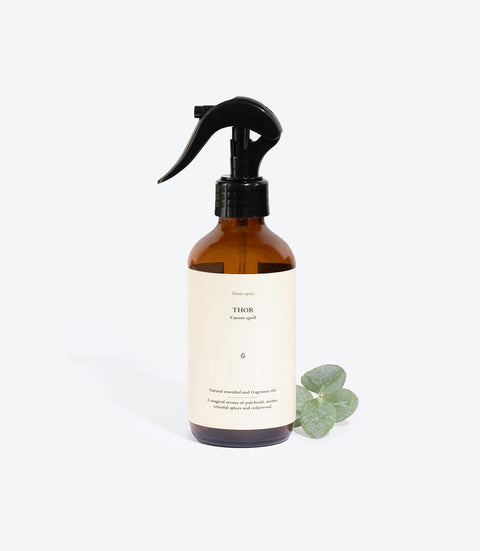 1. Smells Like Spells Perfumed Home Spray THOR in amber bottle with eucalyptus, studio setting