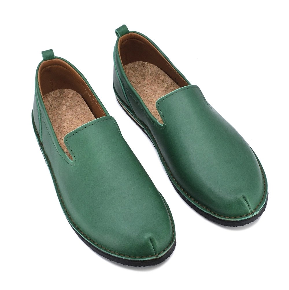 3. Studio image of unisex green TOKU London shoes with cork insole and leather upper