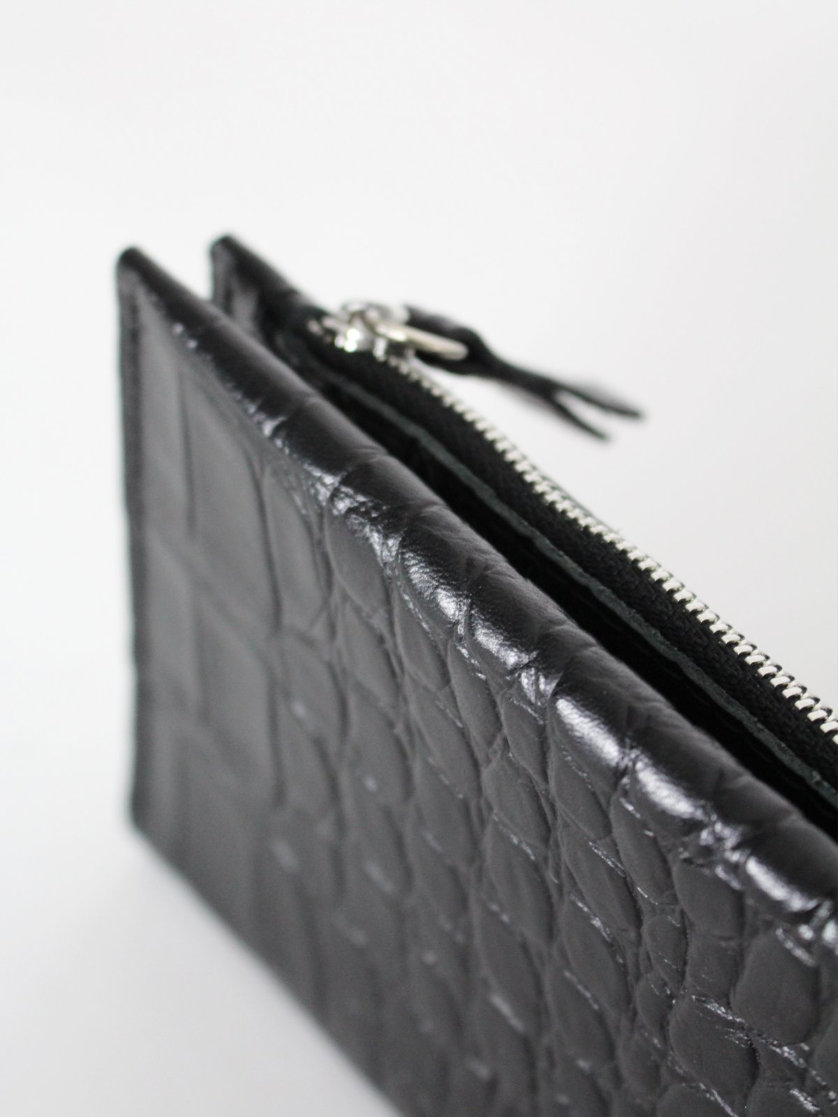 2. Close-up of Classic Leather Wallet TAAL in Black Croco, highlighting zippered section and crocodile texture