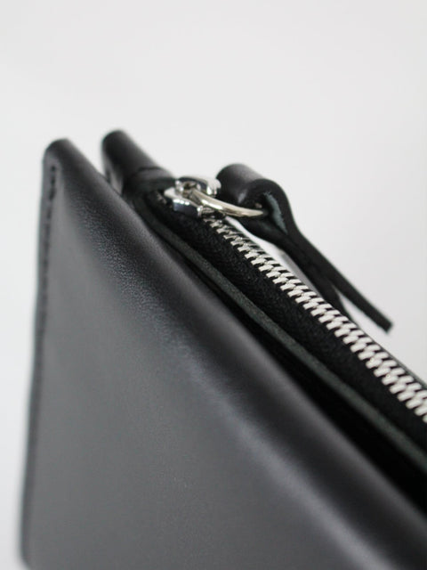 3. Close-up of black Lava flow Classic Leather Wallet TAAL, highlighting zipper detail and craftsmanship