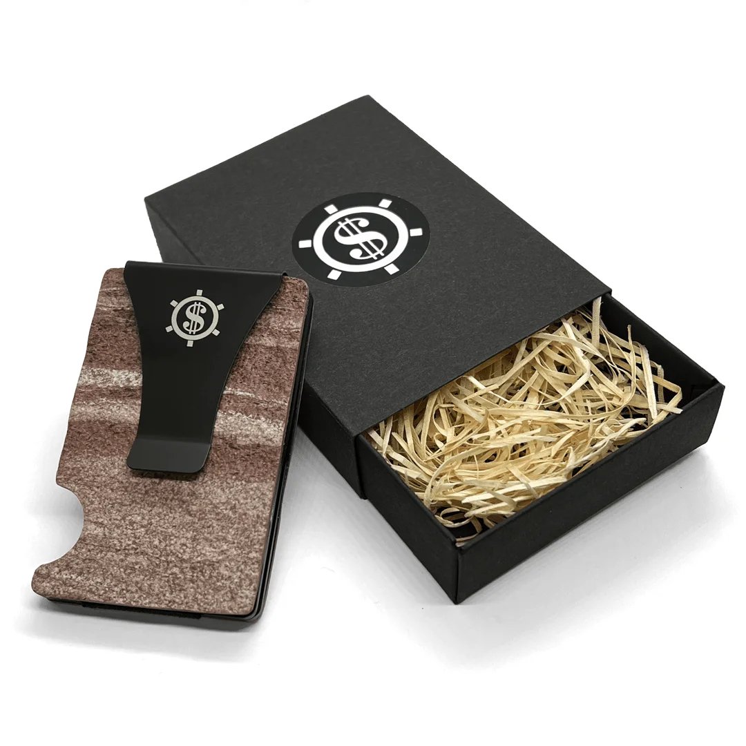 3. Red Canyon marble card holder with black money clip next to open black box with Seif Design logo and straw filling